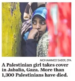 A Palestinian girl takes cover in Jabalia, Gaza. More than 1,300 Palestinians have died. &mdash; The Daily Advertiser, 31 July 2014