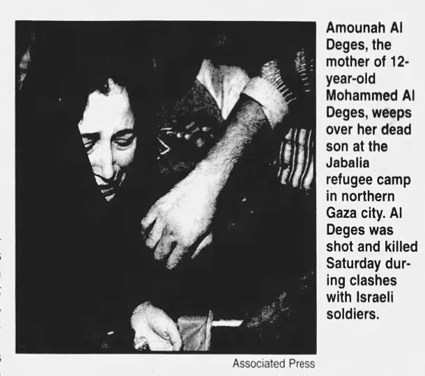 Amounah Al Deges, the mother of 12-year-old Mohammed Al Deges, weeps over her dead son at the Jabalia refugee camp in northern Gaza city — Enterprise Record, 19 November 2000