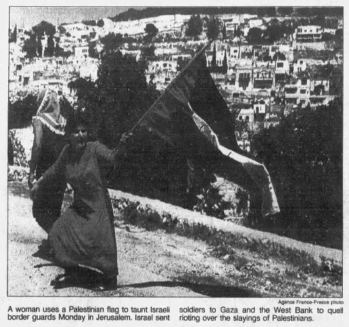 A woman uses a Palestinian flag to taunt Israeli border guards Monday in Jerusalem — Chicago Tribune, 22 May 1990