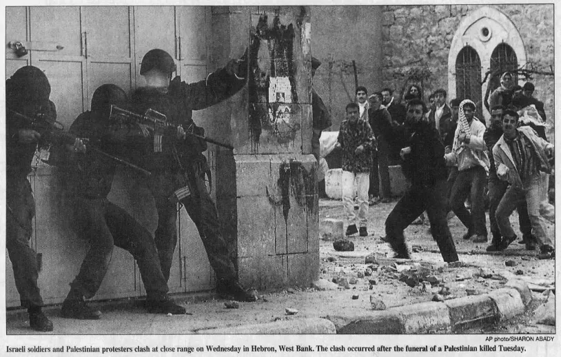 Israeli soldiers and Palestinian protesters clash at close range in Hebron, West Bank. The clash occurred after the funeral of a Palestinian killed Tuesday. — South Florida Sun Sentinel, 10 April 1997