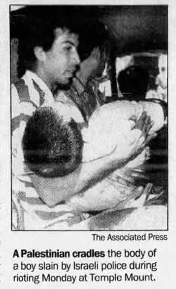 A Palestinian cradles the body of a boy slain by Israeli police during rioting Monday at Temple Mount &mdash; Associated Press, 9 October 1990