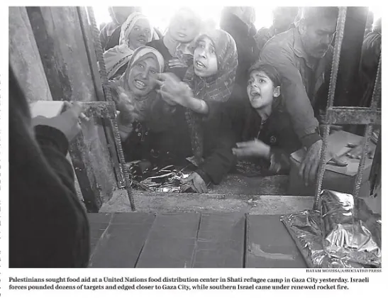 Palestinians sought food aid at a United Nations food distribution center in Shati refugee camp in Gaza City &mdash; The Boston Globe, 11 January 2009