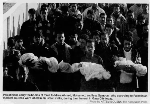 Palestinians carry the bodies of three toddlers Ahmed, Mohamed, and Issa Samouni, killed in an Israeli strike, during their funeral in Gaza City &mdash; Fort McMurray Today, 5 January 2009